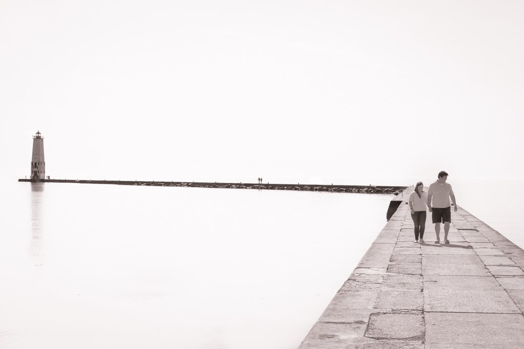 Couple walking on a Breakwall